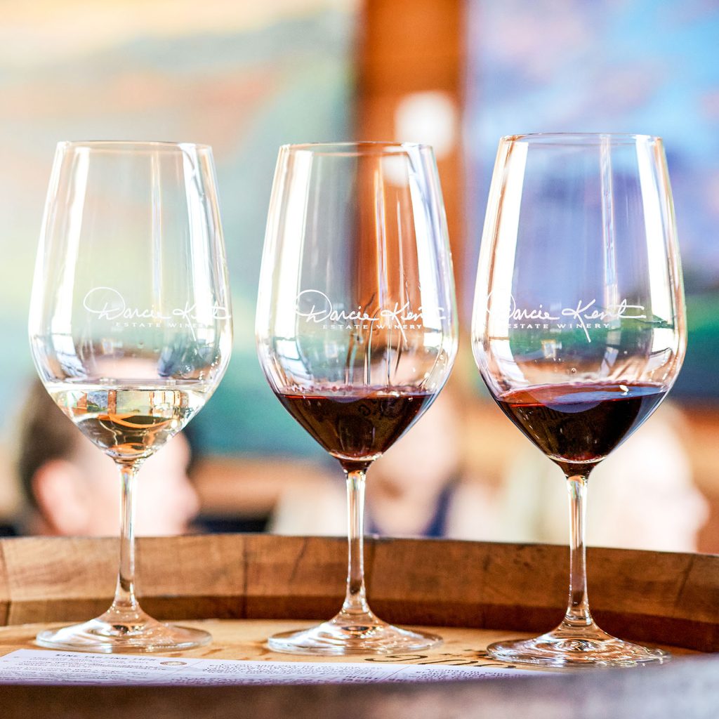 Three wine glasses with Darcie Kent Estate Wines in them in a line for a tasting in our Livermore Wine Tasting Room