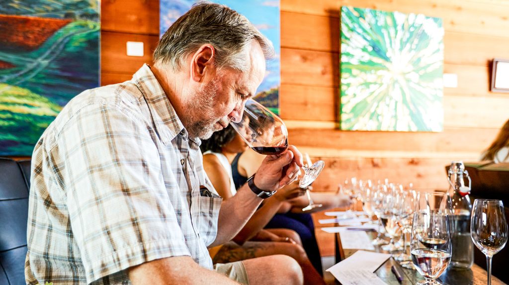 A guest at Darcie Kent Vineyards with his nose in the glass at a wine-tasting experience