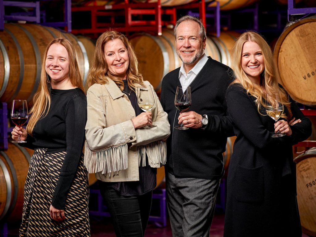 The Kent Family posing in front of wine barrels at Darcie Kent Estate Vineyards – Kailyn, Darcie, David, Amanda (from left to right)