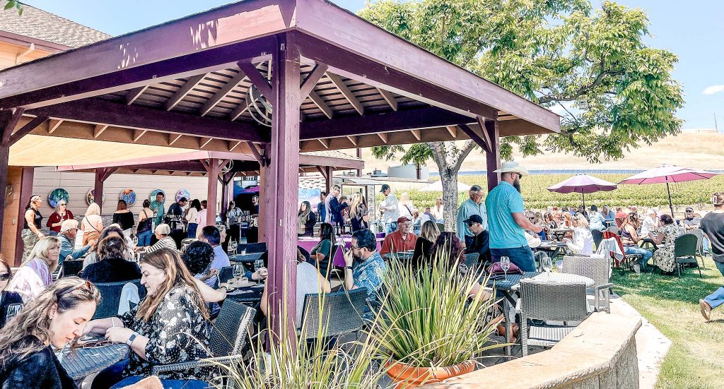 Patrons enjoying wine tasting and food on a lovely afternoon on the shaded patio at Darcie Kent Estate Wines in Livermore, California